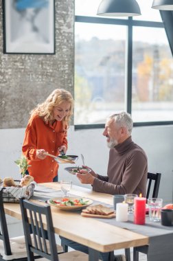 Anniversary dinner. Mature couple having a dinner and looking happy
