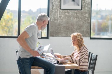Working with papers. A couple looking through papers and discussing something