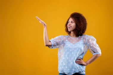 Gestures. A woman in white blouse gesticulating and looking contented