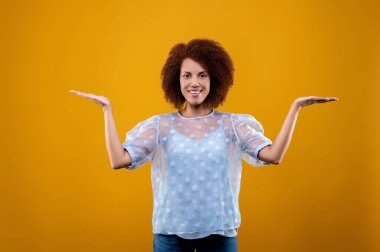 Gestures. A woman in white blouse gesticulating and looking contented