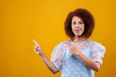Gestures. A woman in white blouse gesticulating and looking contented