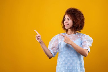Gestures. A woman in white blouse gesticulating and looking contented