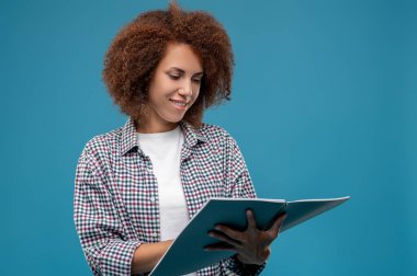 Good project. Young mangaer with project papres in hands looking contented