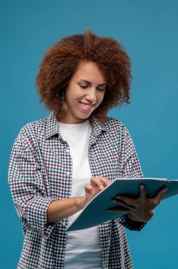 Good project. Young mangaer with project papres in hands looking contented