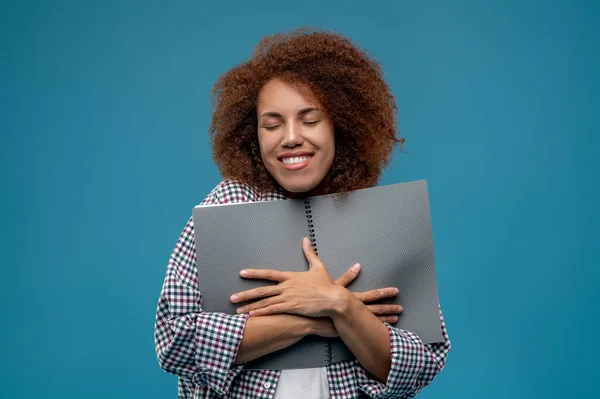 Good deal. Young woman with papers in hands looking pleased and happy