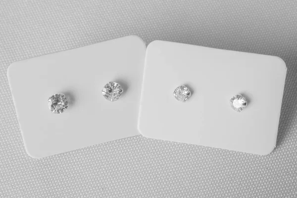 Stylish silver earring jewelry with precious stones. White background. Two pair.