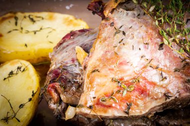 FLANK STEAK beef BBQ food. Meat roasted in a glass dish, with potatoes and thyme. Close view.