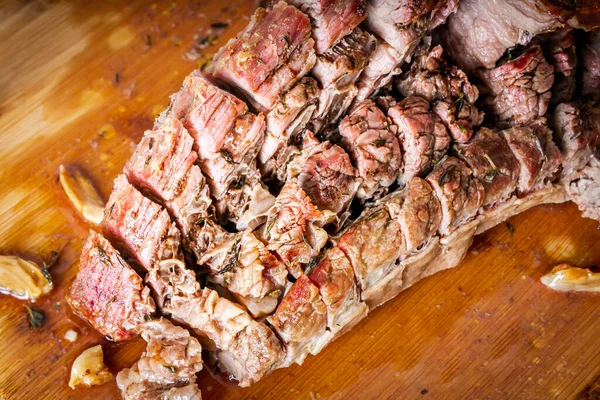 FLANK STEAK beef BBQ food. Roasted meat with potatoes and thyme on a wooden board, completely cut into slices.
