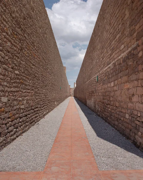 stock image Prison corridor would expenitentiate. Double stone wall with blue sky and clouds, part of the Leonora Carrington Museum, without people