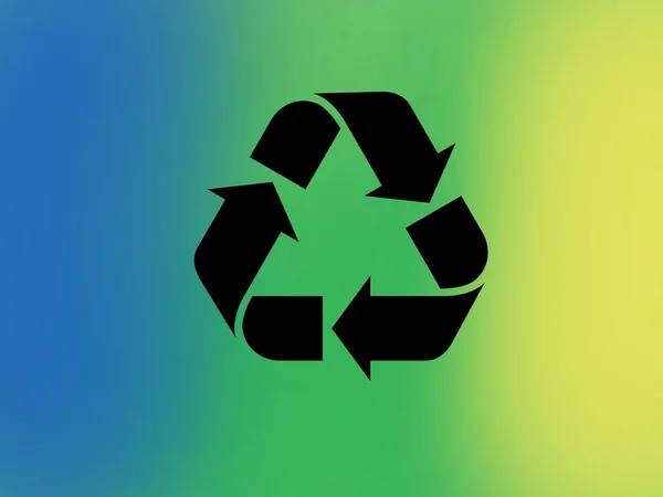 Recycling symbol with a blurred background with the recycling colors, blue, green and yellow. Conservation of the environment and recycling of garbage.