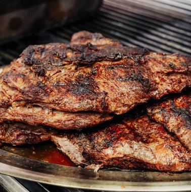 Izgarada kızarmış biftek ama fazla pişmiş.