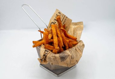 Portion of fried potatoes and sweet potatoes with spicy sauce