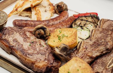 Varied quality meat barbecue with roasted potato