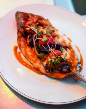 Dish of baked bream with vegetables in a gourmet restaurant