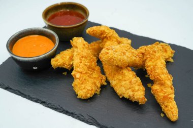 Kentucky-style battered chicken strips with barbecue sauce