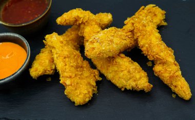 Kentucky-style battered chicken strips with barbecue sauce