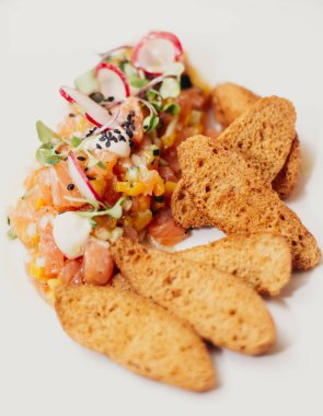 Gourmet salmon ceviche dish with whole wheat toast