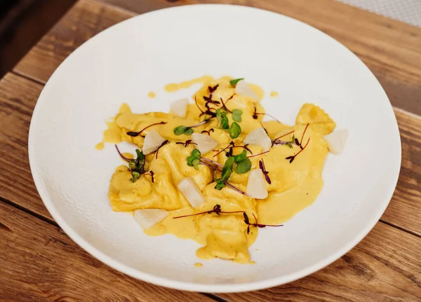 stock image In this photo, we see a plate of homemade Italian pasta with a delicious sauce. The pasta is perfectly cooked and has a beautiful golden color, with a slightly rough texture.