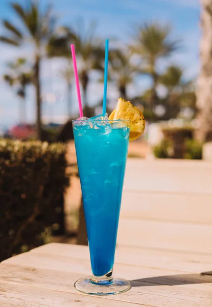 Basic blue cocktail, a mix of blue curaao with a clear spirit such as vodka or rum,  some citrus juice or soda for balance