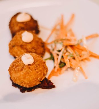 Portion of gourmet chicken, seafood and ham croquettes