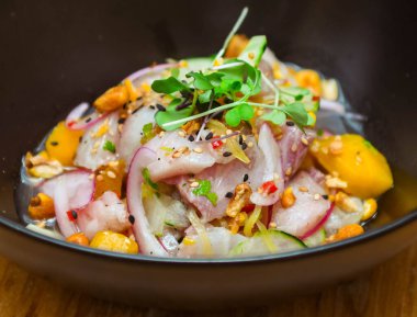 Gourmet plate of sea bass and red onion ceviche