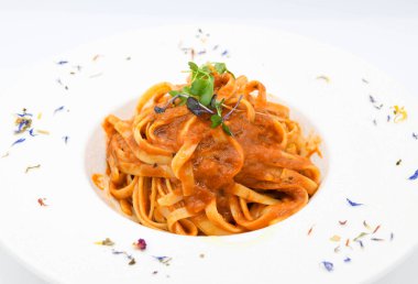 Noodles bolognese with tomato sauce on a white plate clipart