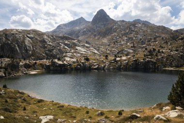 Beautiful landscape of the natural park of Aigestortes y Estany de Sant Maurici, Pyrenees valley with river and lake clipart