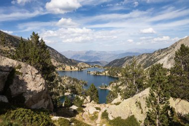 Beautiful landscape of Black lake (Estany negre) in the natural park of Aigestortes y Estany de Sant Maurici, Pyrenees valley with river and lake clipart