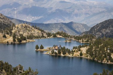 Beautiful landscape of Black lake (Estany negre) in the natural park of Aigestortes y Estany de Sant Maurici, Pyrenees valley with river and lake clipart