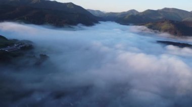 Aerial top view of inverse cloud cover in the light of the morning sun, Misty landscape. . High quality 4k footage