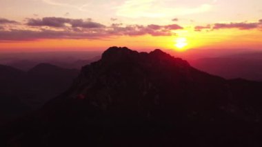 A beautiful sunset over a rocky mountain. Flying over the top of the mountain. 4K. High quality 4k footage