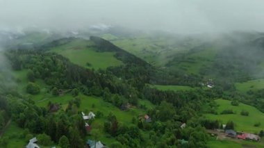Karpatlar 'daki canlı yeşil bahar kırsal manzarasını gösteren hava hipervanesi, yağmurdan sonra kalan sis ve alçak bulutlar, dingin ve ferahlatıcı bir atmosfer yaratıyor..
