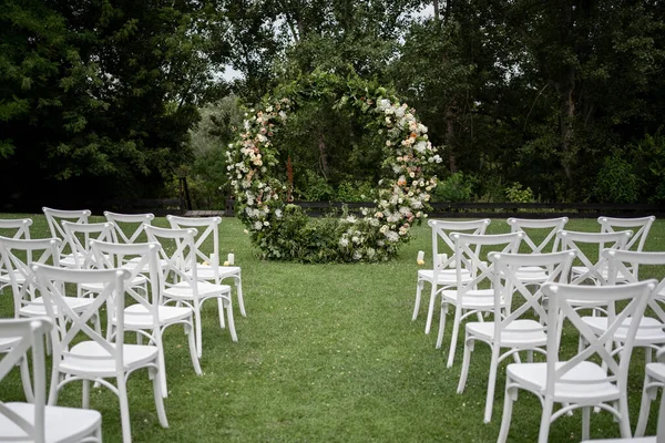 stock image Wedding ceremony. Very beautiful and stylish wedding arch, decorated with various fresh flowers, standing in the garden. Wedding day. Fresh flowers decorations, Peony weddng.