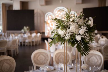 Luxury wedding table setting with flower centerpieces and candles. Wedding day.