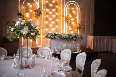 Luxury wedding table setting with flower centerpieces and candles. Wedding day.