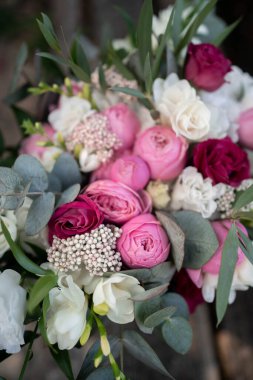 Wedding bouquet composed of roses, ozothamnus, freesia and eucalyptus. Pink bridal bouquet.