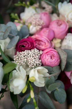Wedding bouquet composed of roses, ozothamnus, freesia and eucalyptus. Pink bridal bouquet.