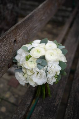 Wedding bouquet of white flowers - ranunculus, freesia, lisianthus.. Bride and groom. Wedding Dress