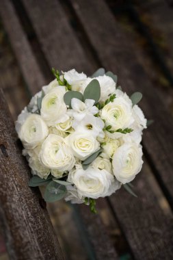 Wedding bouquet of white flowers - ranunculus, freesia, lisianthus.. Bride and groom. Wedding Dress