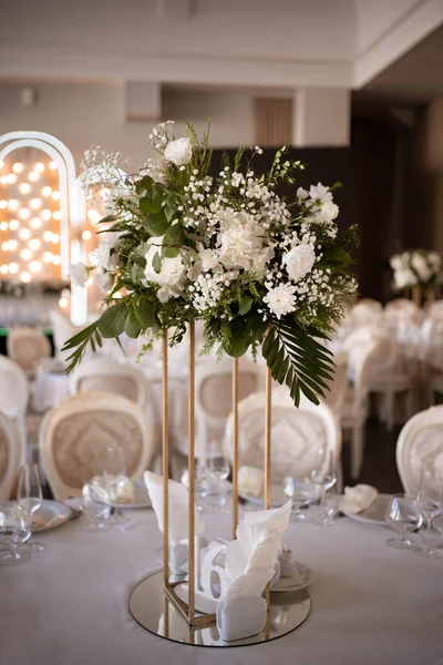 Luxury wedding table setting with flower centerpieces and candles. Wedding day.
