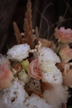 Beautiful wedding bouquet in vintage style. Boho bridal bouquet composed of lisianthus, pampas grass, roses and dried flowers.