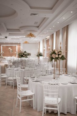 Wedding table set up in boho style with pampas grass and greenery, soft focus. Wedding day.