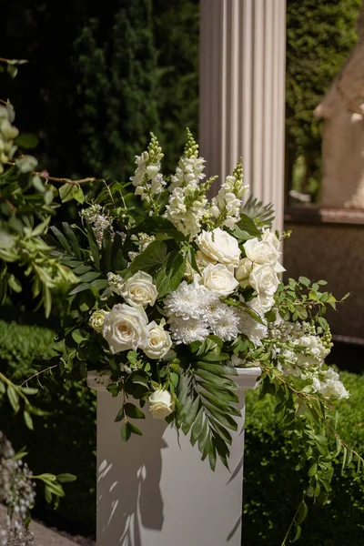 White and green flower wedding arrangement. Wedding day.