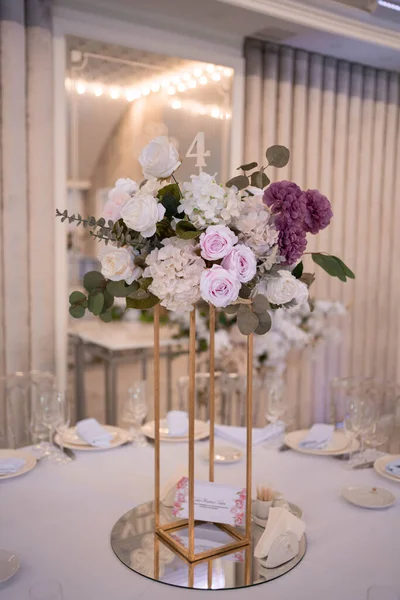 Table setting at a luxury wedding reception. Beautiful flowers on the table. Wedding day.