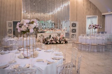Table setting at a luxury wedding reception. Beautiful flowers on the table. Wedding day.