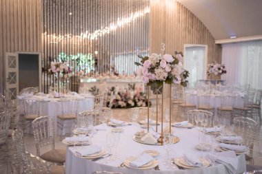 Table setting at a luxury wedding reception. Beautiful flowers on the table. Wedding day.