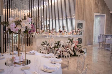 Table setting at a luxury wedding reception. Beautiful flowers on the table. Wedding day.