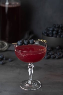 Fresh berries cocktail with bluenerries. Summer cold drink and cocktail on dark background.