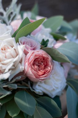 Pink bridal bouquet with ribbons. Wedding bouquet composed of roses and eucalyptus