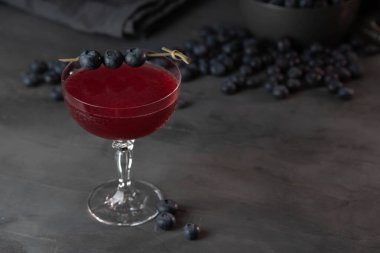 Fresh berries cocktail with bluenerries. Summer cold drink and cocktail on dark background.
